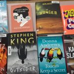 books displayed on a counter. Danielle steel, dean koontz, stephen king, the hunger, kevin kwan, donna andrews, paulo coelho